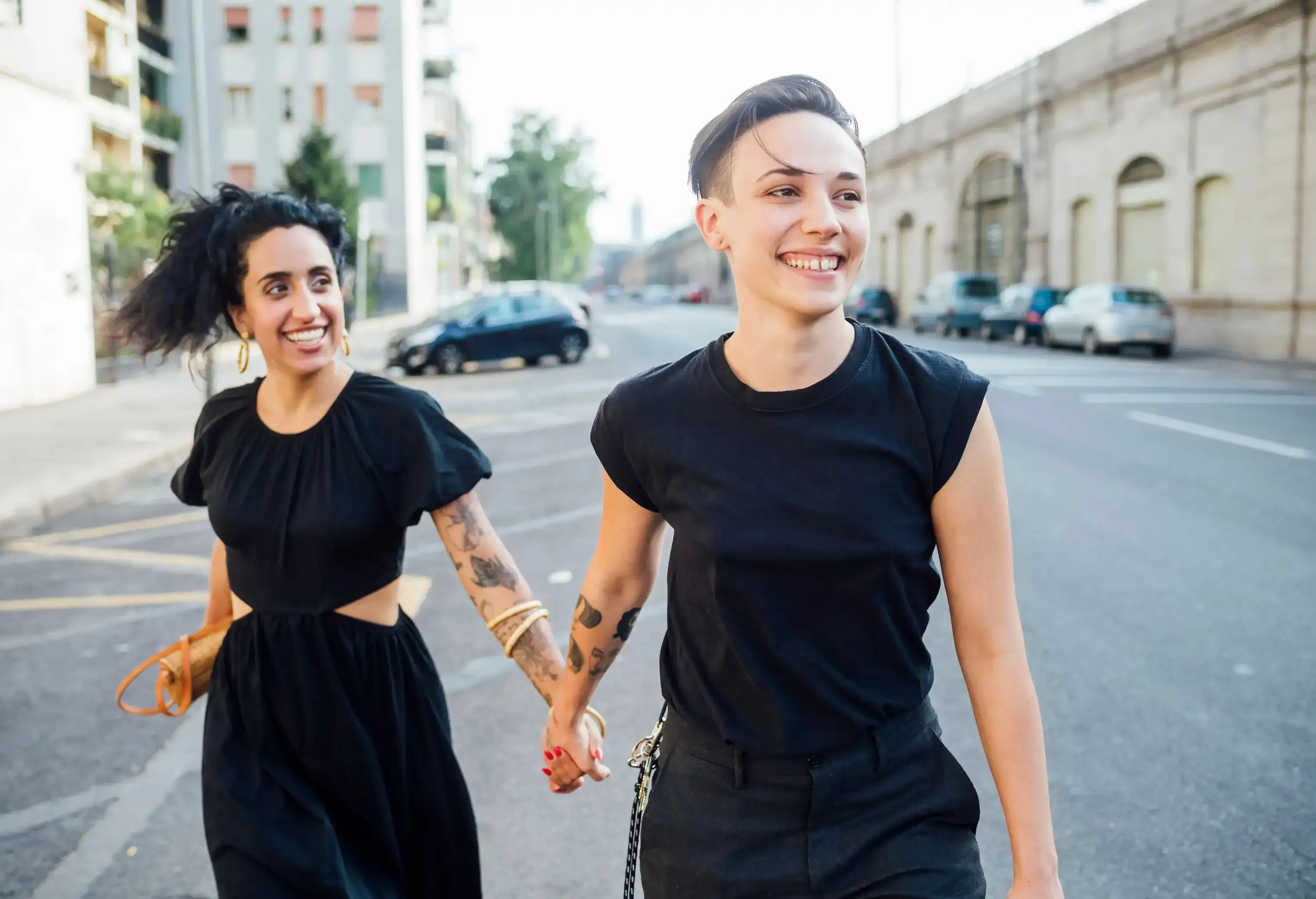 Smiling lesbian couple walking in city