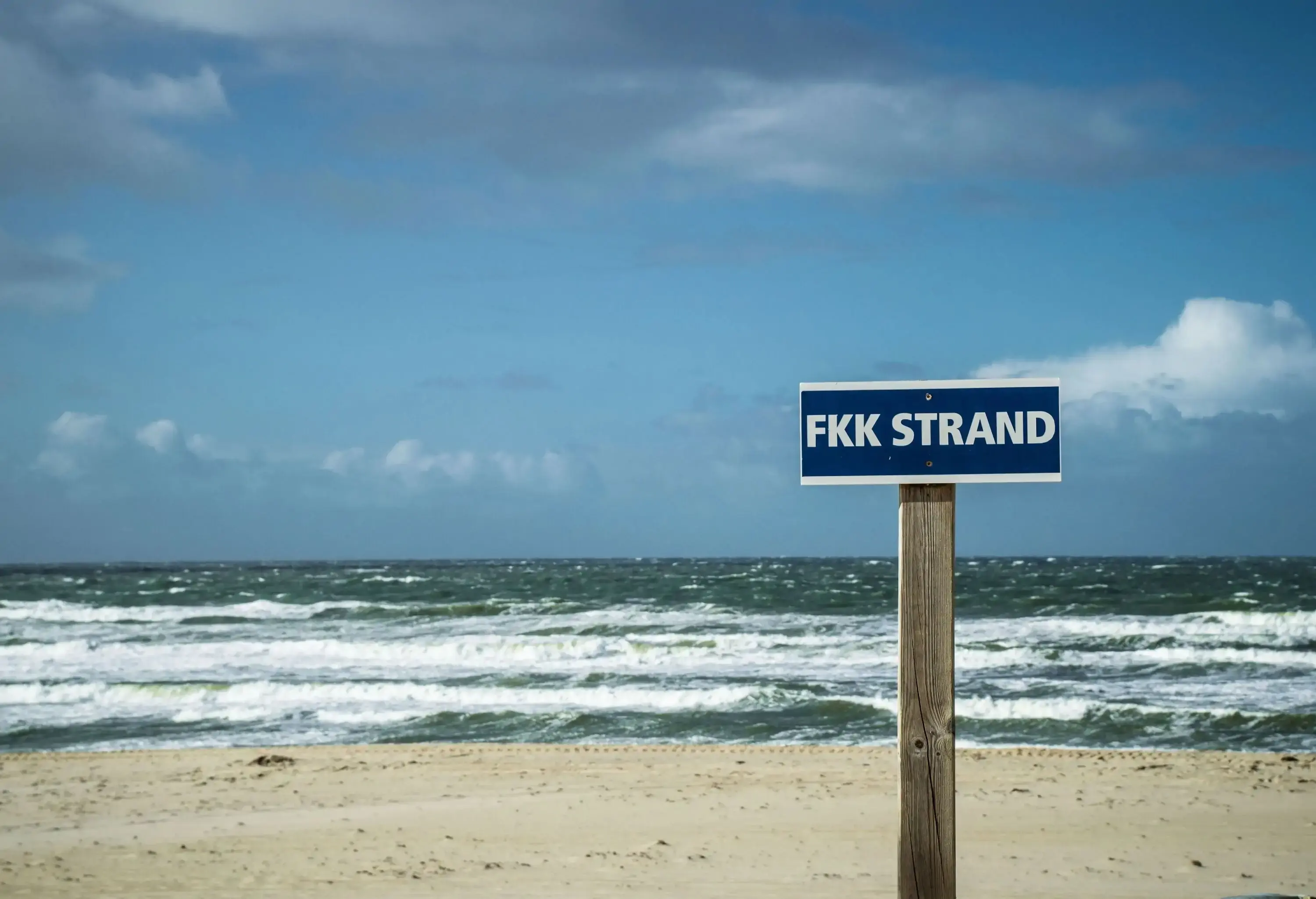 A beach with crashing waves and the words 