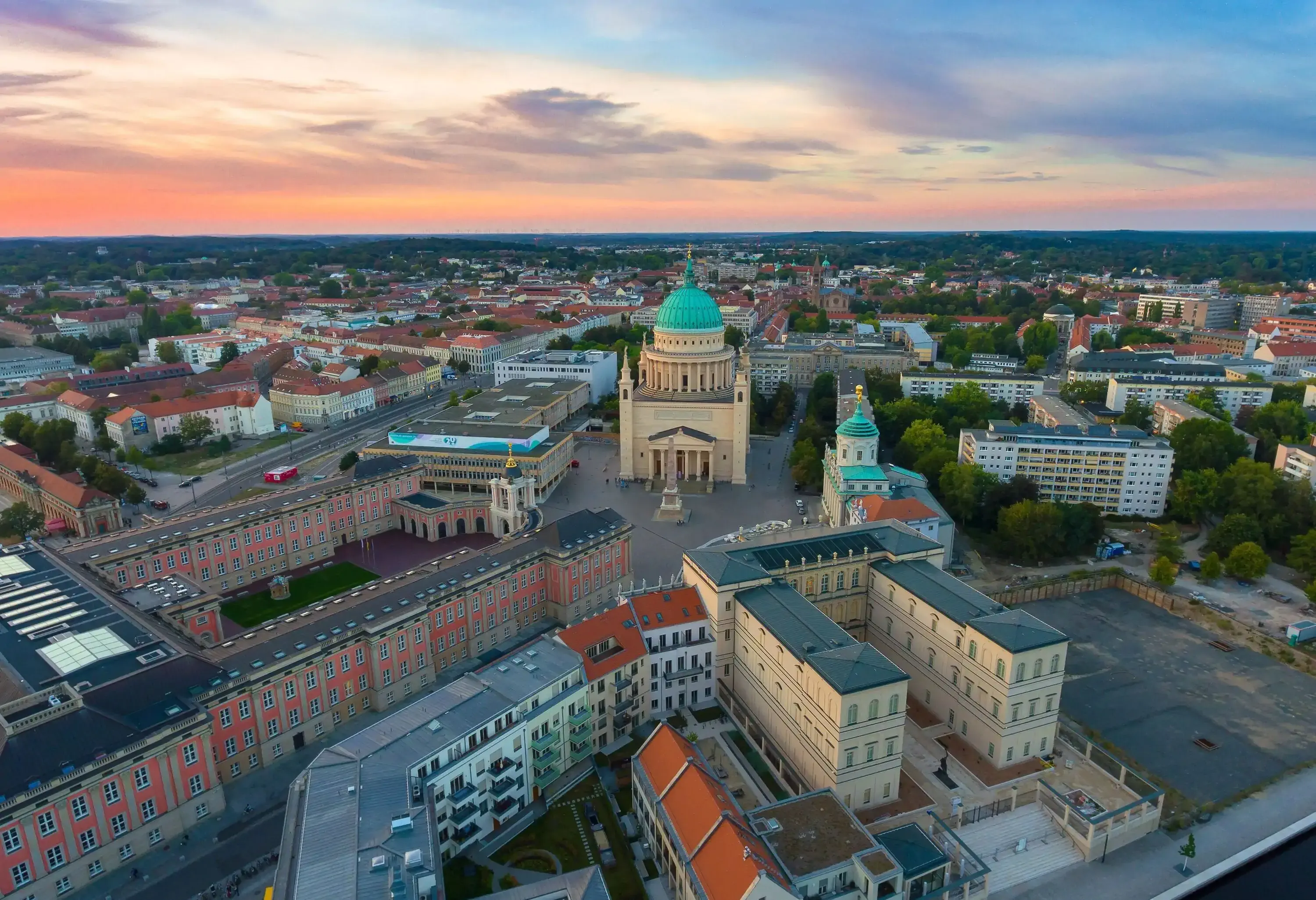 A town square surrounded by Renaissance-style structures, with a church and a palace.