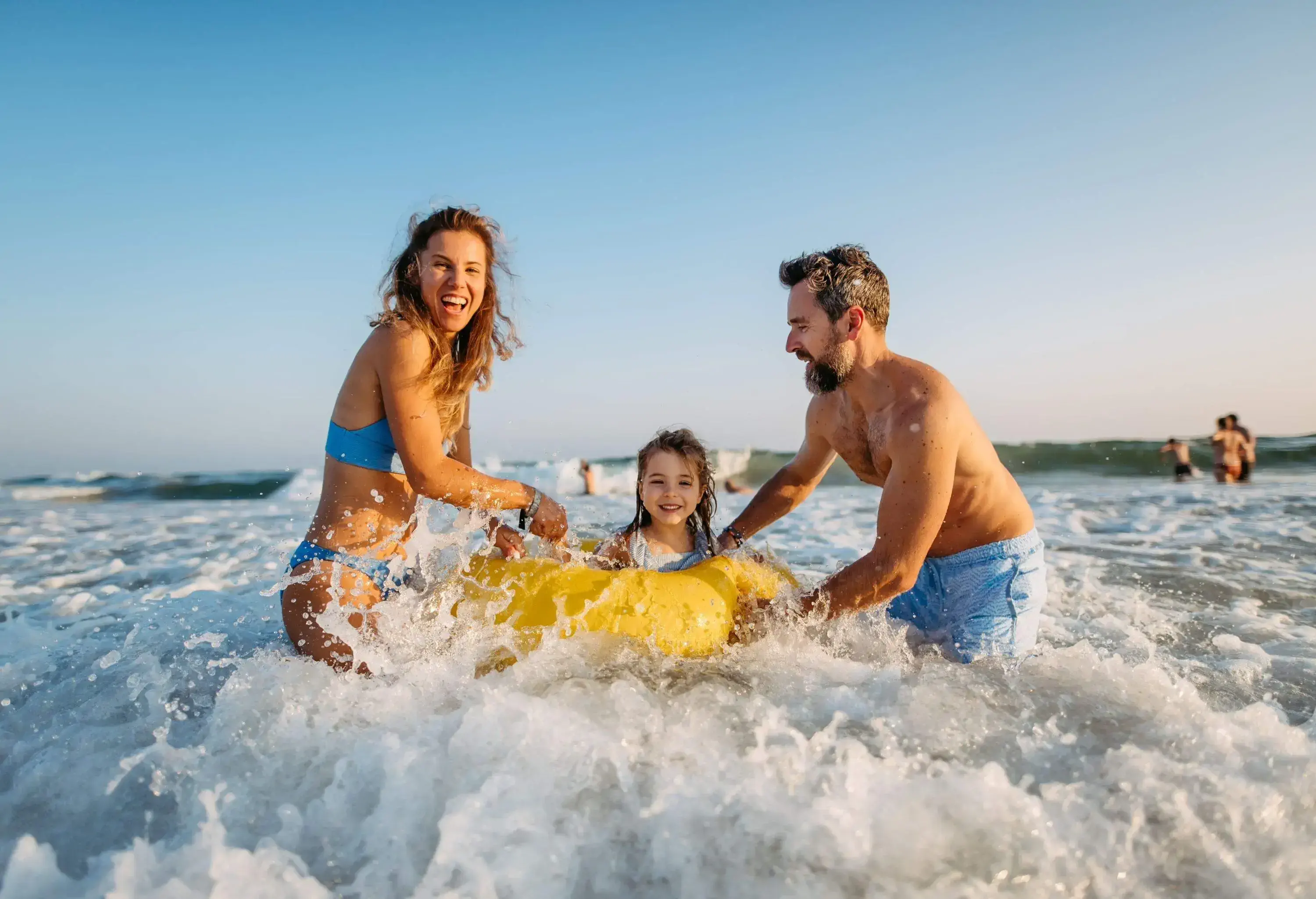 A family swimming in the ocean and waves