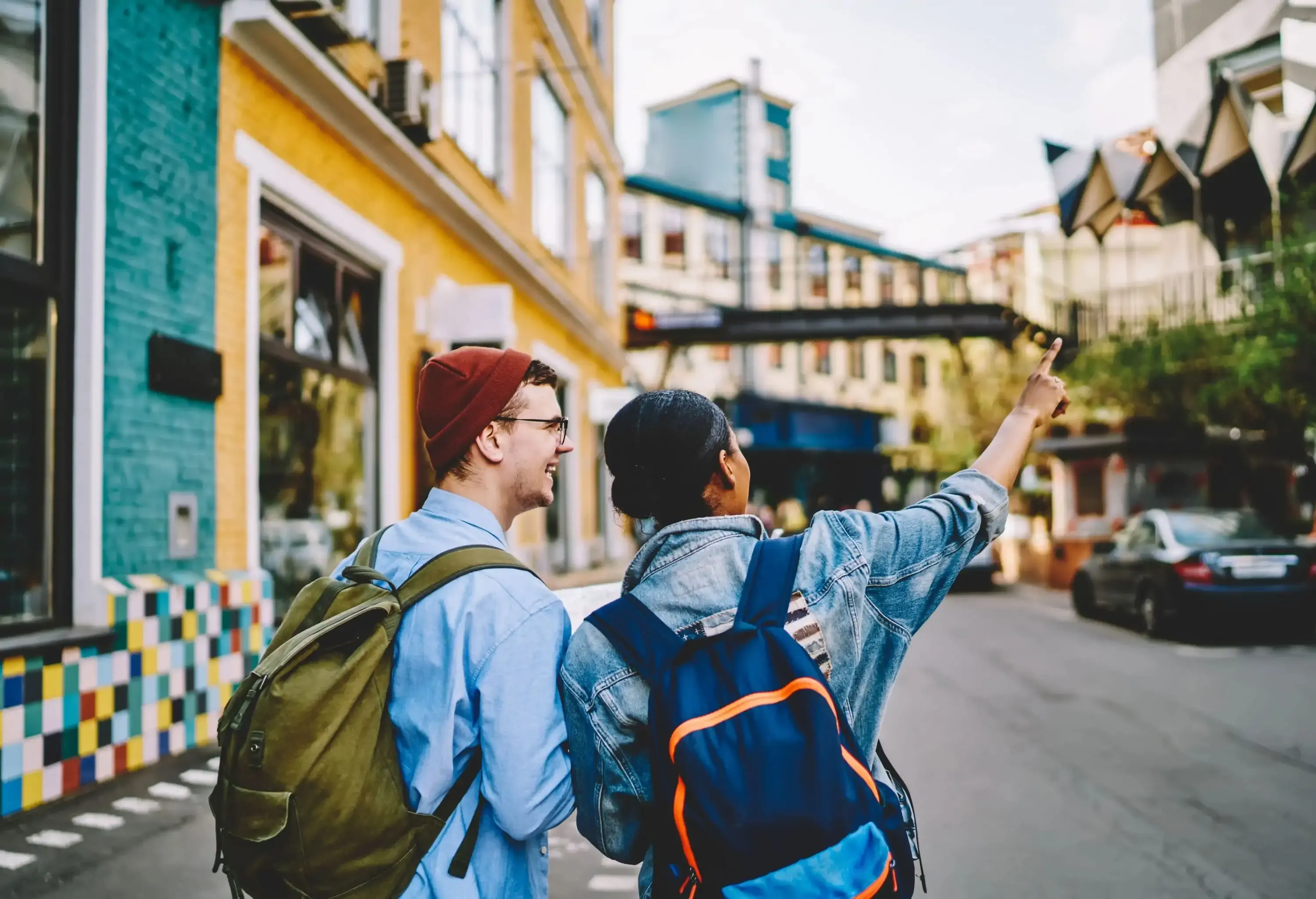 Two fashionable men looking around the city and admiring its architecture.