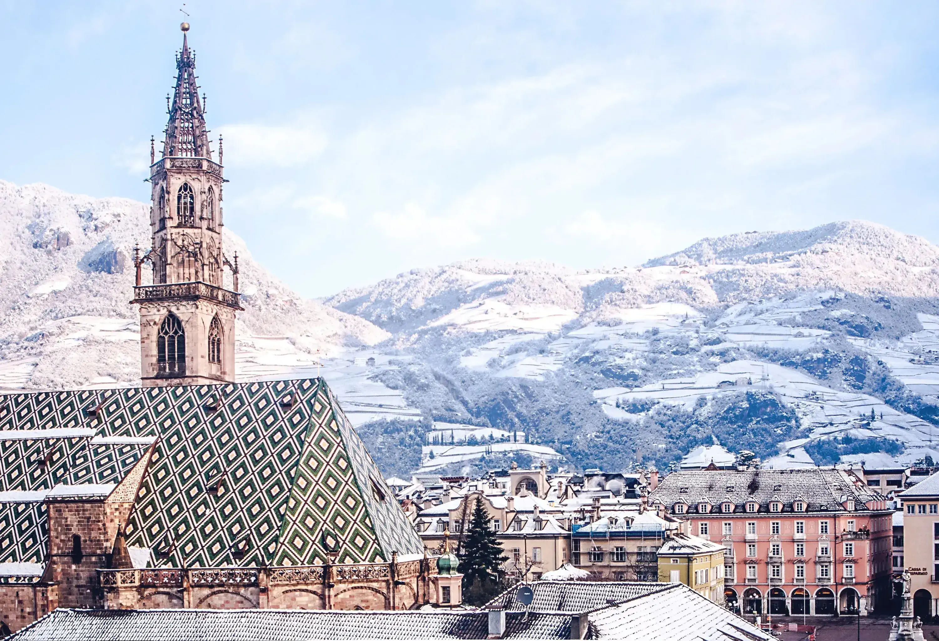 A stunning snow-covered cityscape with rough slopes, featuring a majestic cathedral that dominates the skyline.