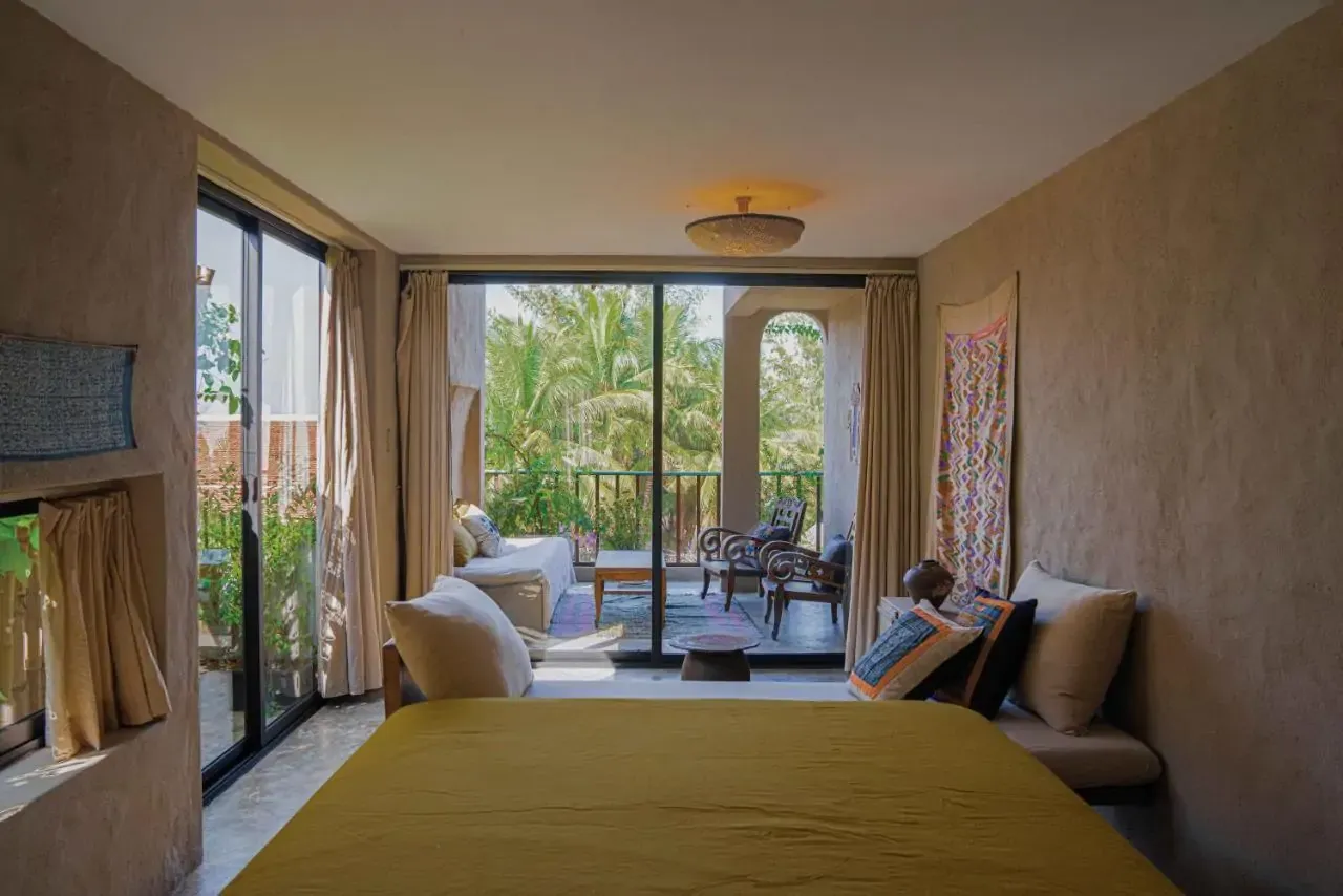 Hotel room with two large windows overlooking greenery in a tropical place